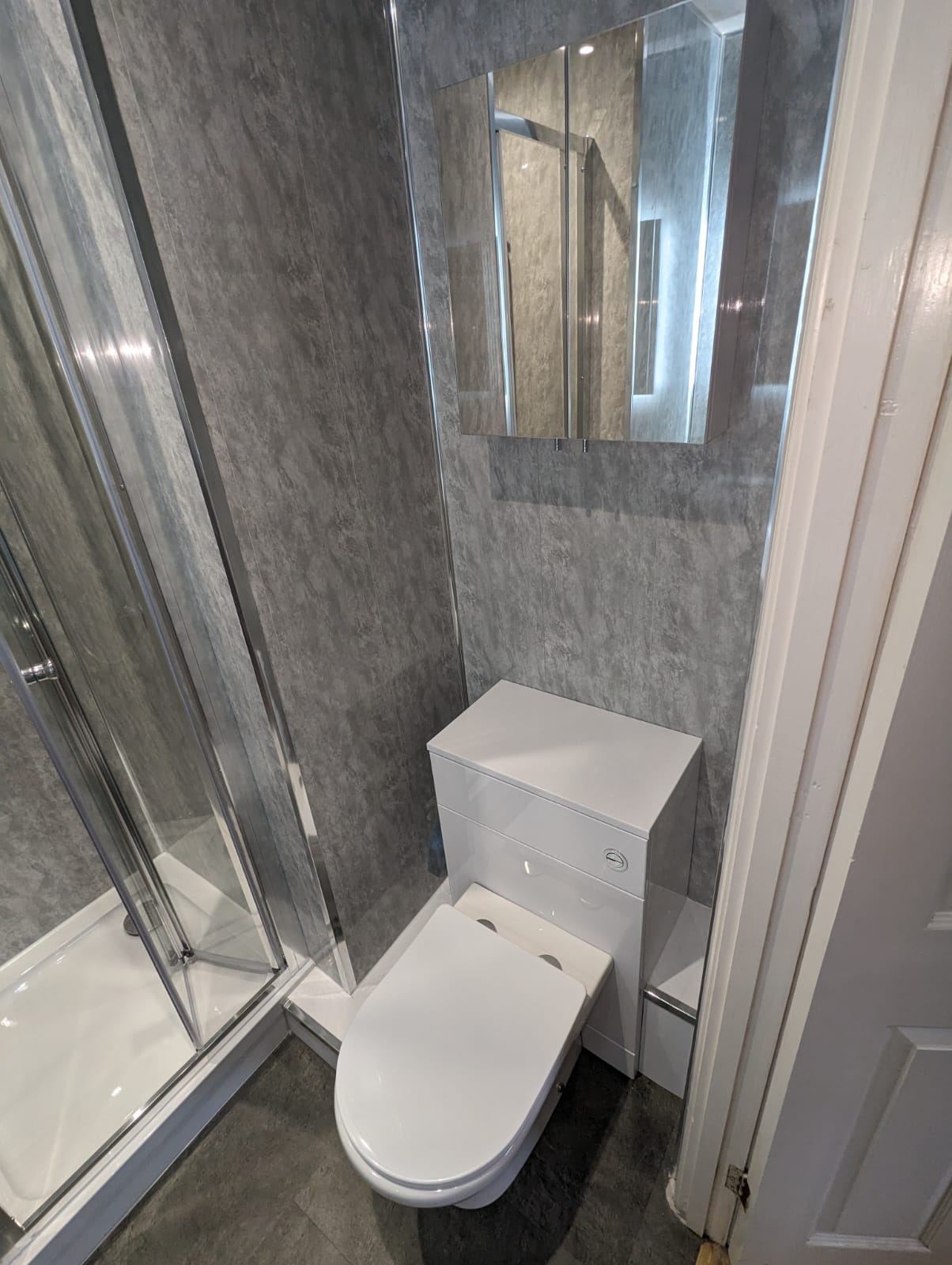 Compact bathroom with grey marble wall panels